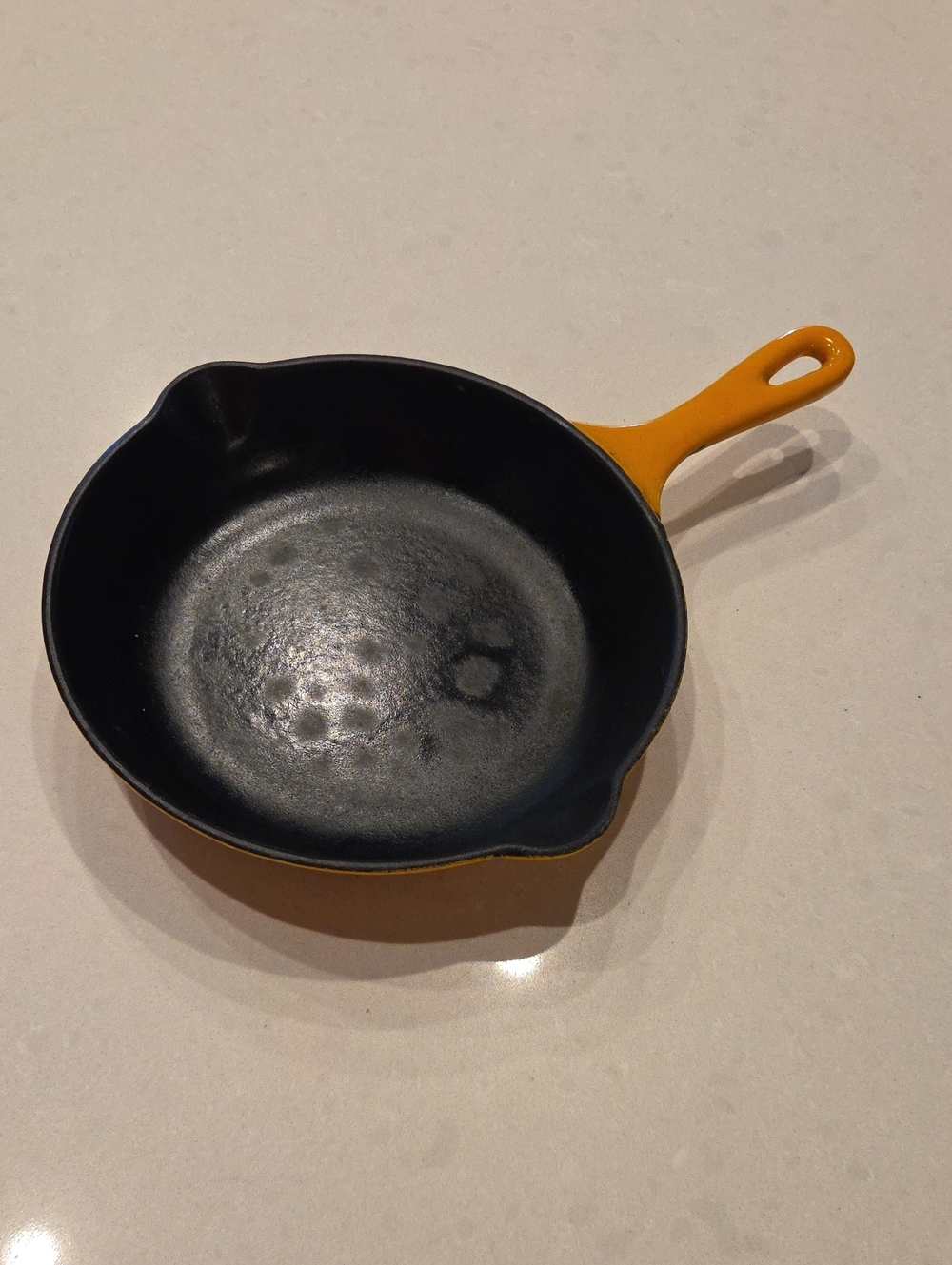 Le Creuset Orange Enameled Cast Iron Skillet with Black Interior